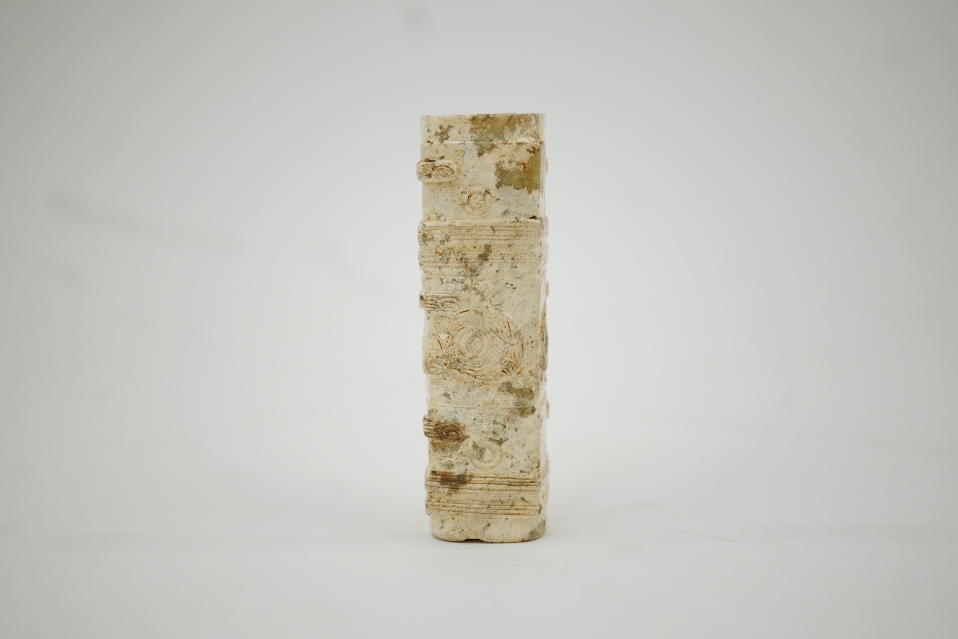 Four Chinese archaistic hardstone or burnt jade cong or cylinders